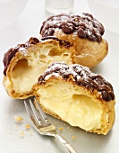 Whole and halved profiteroles filled with vanilla cream