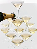Pouring champagne into a pyramid of glasses