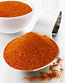 Chilli powder on a spoon and in a glass bowl