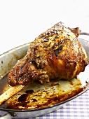Roast leg of lamb in a roasting dish
