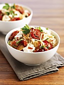 Linguine with tomatoes and mozzarella in two bowls