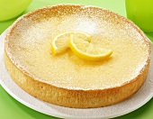 A lemon tart on a cake plate