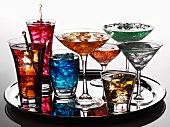 Various coloured cocktails on a tray