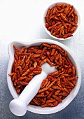 Dried chillies in a mortar and a small dish