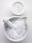 Coarse sea salt in a mortar and a small dish