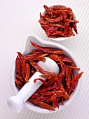 Dried chillies in a mortar and a small dish