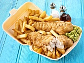 Fish and chips with mushy peas in a polystyrene container