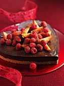 Heart-shaped chocolate cake with berries for Valentine's Day