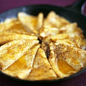 Several crêpes in a frying pan