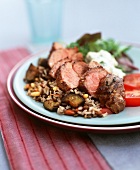 Grilled saddle of lamb on a bed of vegetable rice