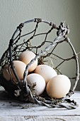 Fresh eggs in a wire basket