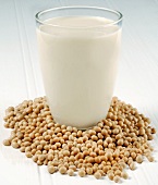 A glass of soya milk and soya beans