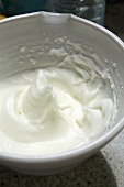 Beaten egg white in a mixing bowl