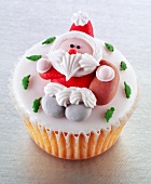 Cupcake with fondant icing and a sugar Father Christmas