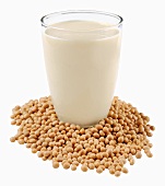 A glass of soya milk on soya beans