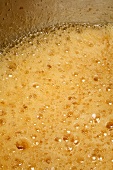 Orange marmalade boiling in a pan