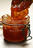 Filling a jar with orange marmalade