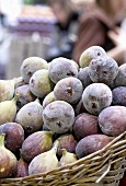 A basket of ripe figs on a market stall