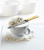 Flour in cup with knife