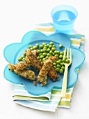 Breaded strips of fish with peas