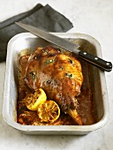 Leg of lamb studded with herbs and garlic, with lemon