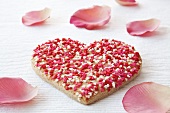 Heart-shaped biscuit with rose petals