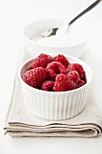 Fresh raspberries in a ramekin, yoghurt