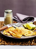 Pancakes with sugar and lime wedges