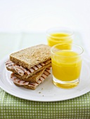 Toasted ham sandwich with orange juice
