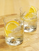Drinks with a slice of lemon and ice cubes