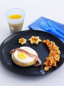 Childrens breakfast with fried egg and space pasta shapes
