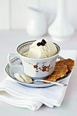 A cup of coffee and ice cream with biscuits