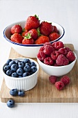 Strawberries, blueberries and raspberries in bowls