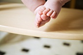 Baby's feet on high chair