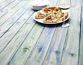 Chicken tikka pizza on a wooden table