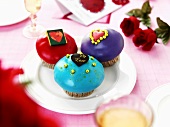 Muffins with coloured icing and hearts