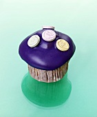 Muffin with purple icing and fizzy sweets