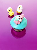 A muffin with turquoise icing and a jelly Easter Bunny for Easter
