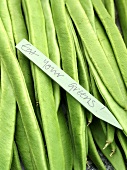 Runner beans with an 'Eat your greens' label (close-up)