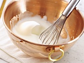Beating egg white in a copper bowl