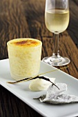 Rice pudding with vanilla cream, glass of white wine