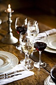 Glasses of different wines on rustic wooden table