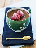 Chocolate pudding with sugared raspberries in a cup