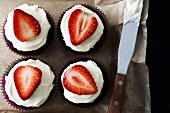 Chocolate muffins with strawberries and cream