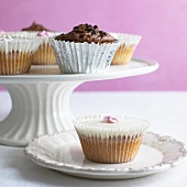 Assorted cupcakes on cake stand and plate