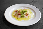 Fish carpaccio with chilli rings and cress