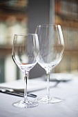 Empty wine glasses on laid table