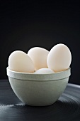 Several duck eggs in ceramic bowl