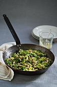 Leeks and cannellini with mustard sauce in frying pan