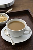 Instant coffee with milk in cup and saucer